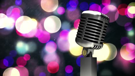 Retro-metallic-microphone-against-purple-spots-of-light-against-black-background