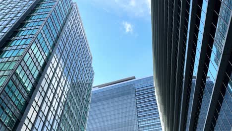 Tall-modern-skyscrapers-with-glass-facades-reflecting-a-clear-blue-sky