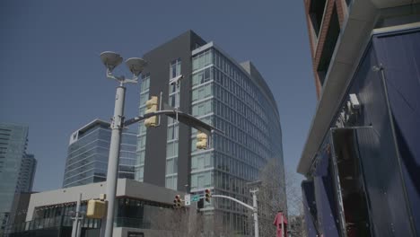 This-wide-shot-captures-a-modern-part-of-Nashville,-showing-a-mix-of-new-architecture-with-the-clear-blue-sky-above