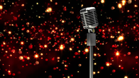 Retro-metallic-microphone-against-red-spots-of-light-against-black-background