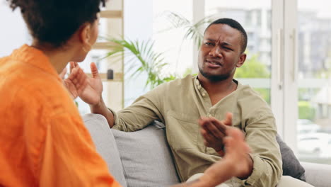 Couple,-home-and-fight-on-living-room-sofa