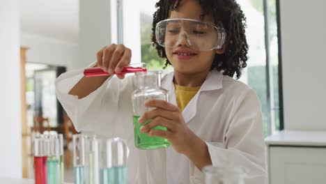 Animation-of-shapes-over-african-american-schoolboy-at-science-class