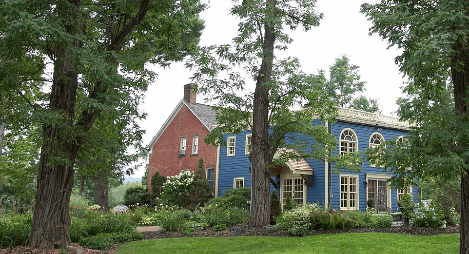 blue panel two story house and red brick tow story house