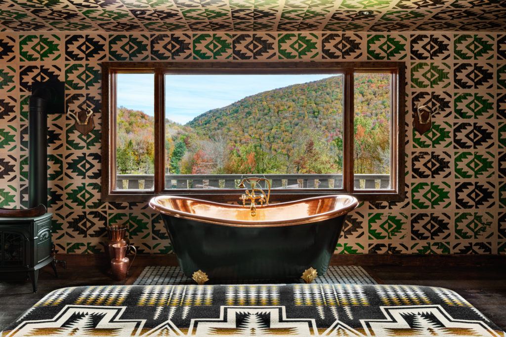 brass bathtub and green bathroom of the urban cowboy lodge