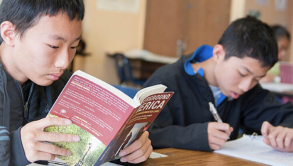 students reading oral history books in class