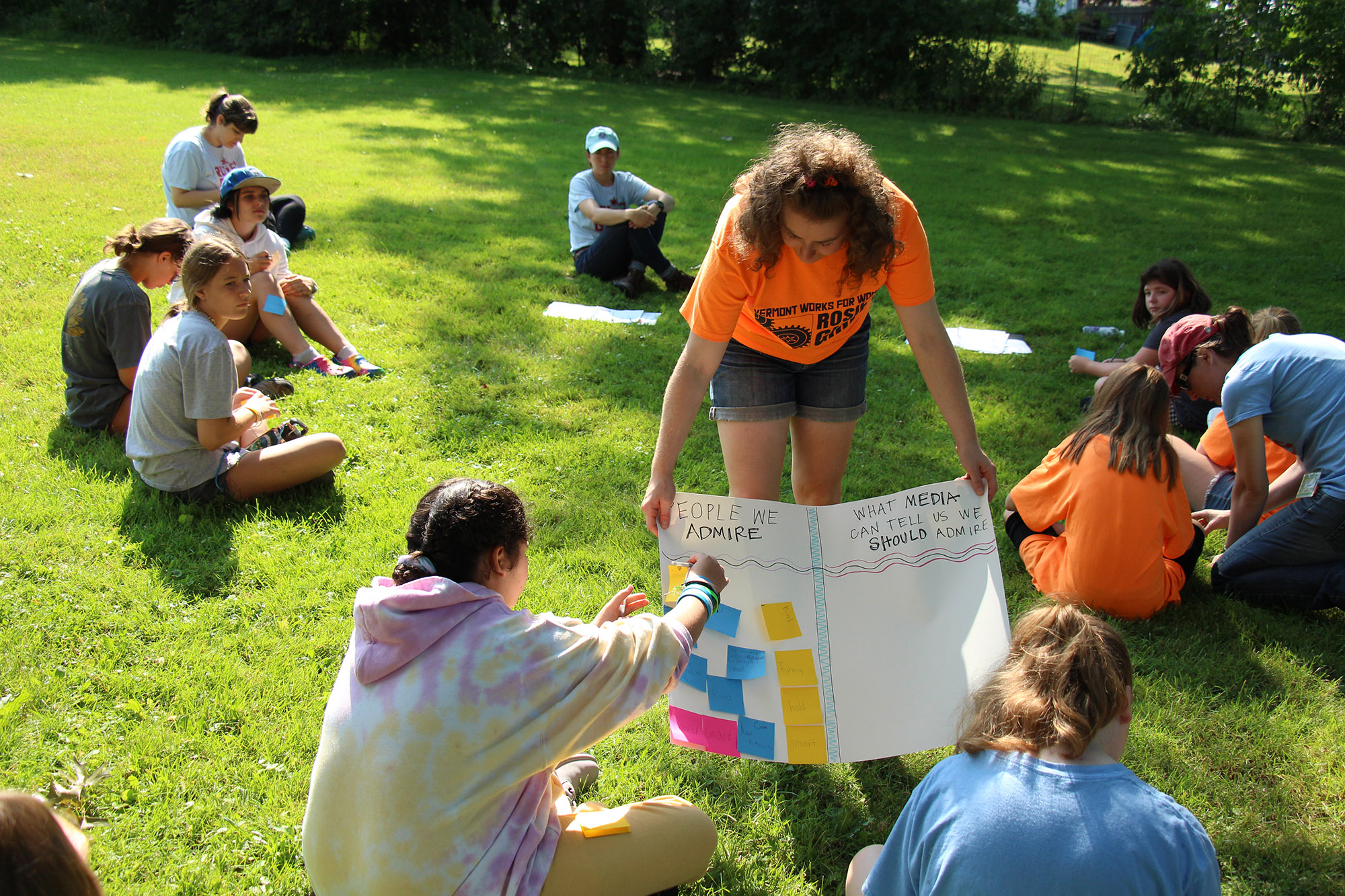 A VWW staff member holds poster board while teaching Rosie’s Girls power skills curriculum.