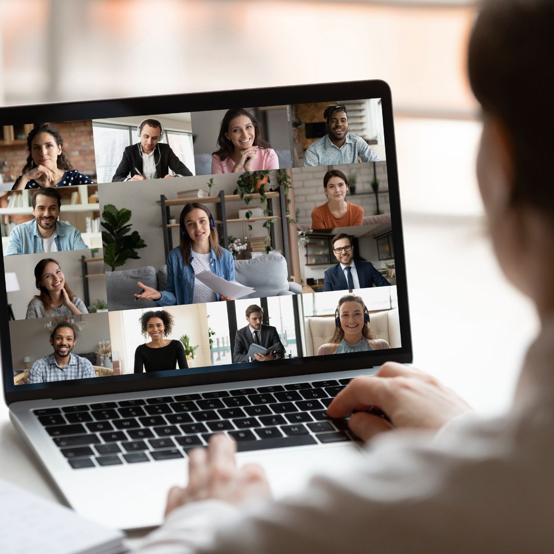 Woman looks at her computer, participating in a virtual meeting, exemplifying Vermont Works for Women's virtual Gender Equity Advancement Roundtable or GEAR program.