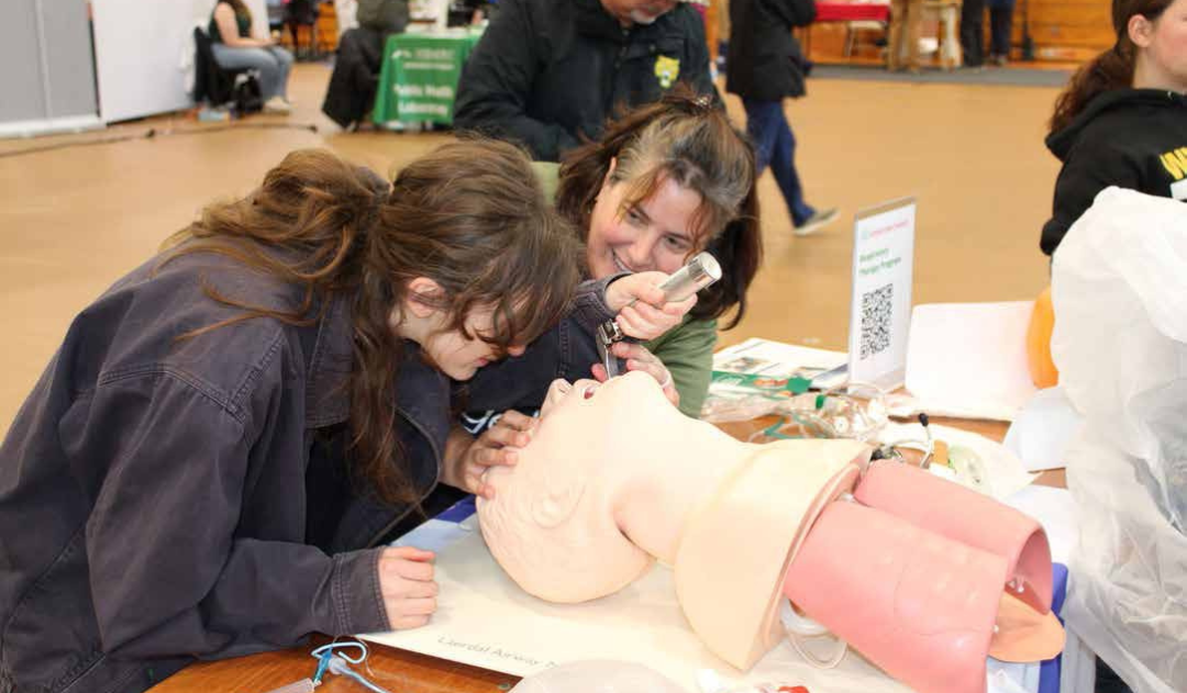 Darcy Lafreniere, a respiratory therapist, leads Juniper Book, a student at Hazen Union High School, in a demonstration on how to intubate a patient who needs a ventilator. (Herald/Isabel Dreher)