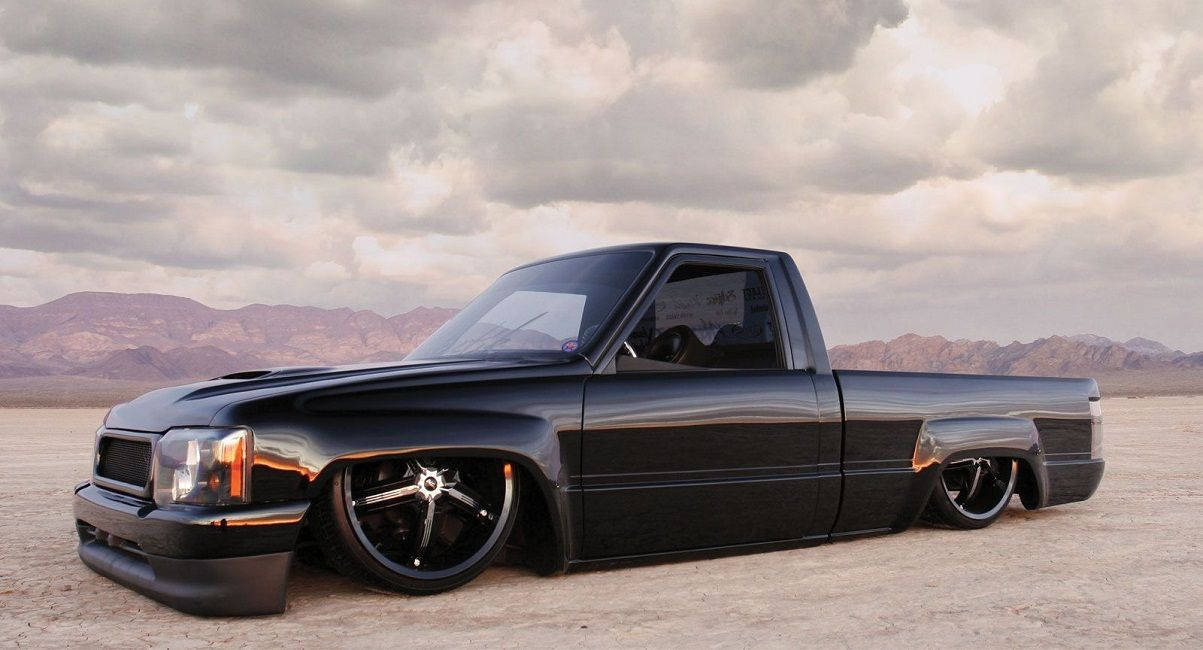 Black Dropped Truck On Sand Wallpaper