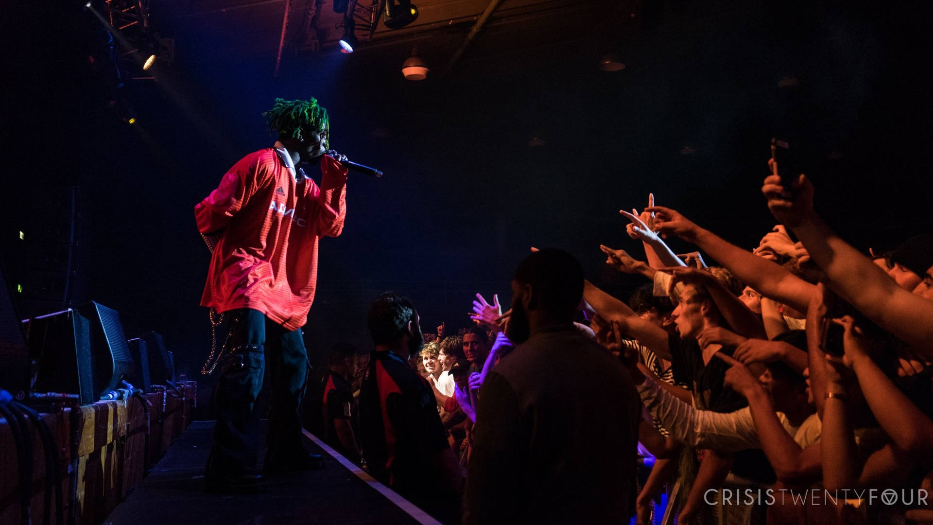 Lil Uzi Vert laying back on a galaxy-patterned desktop Wallpaper