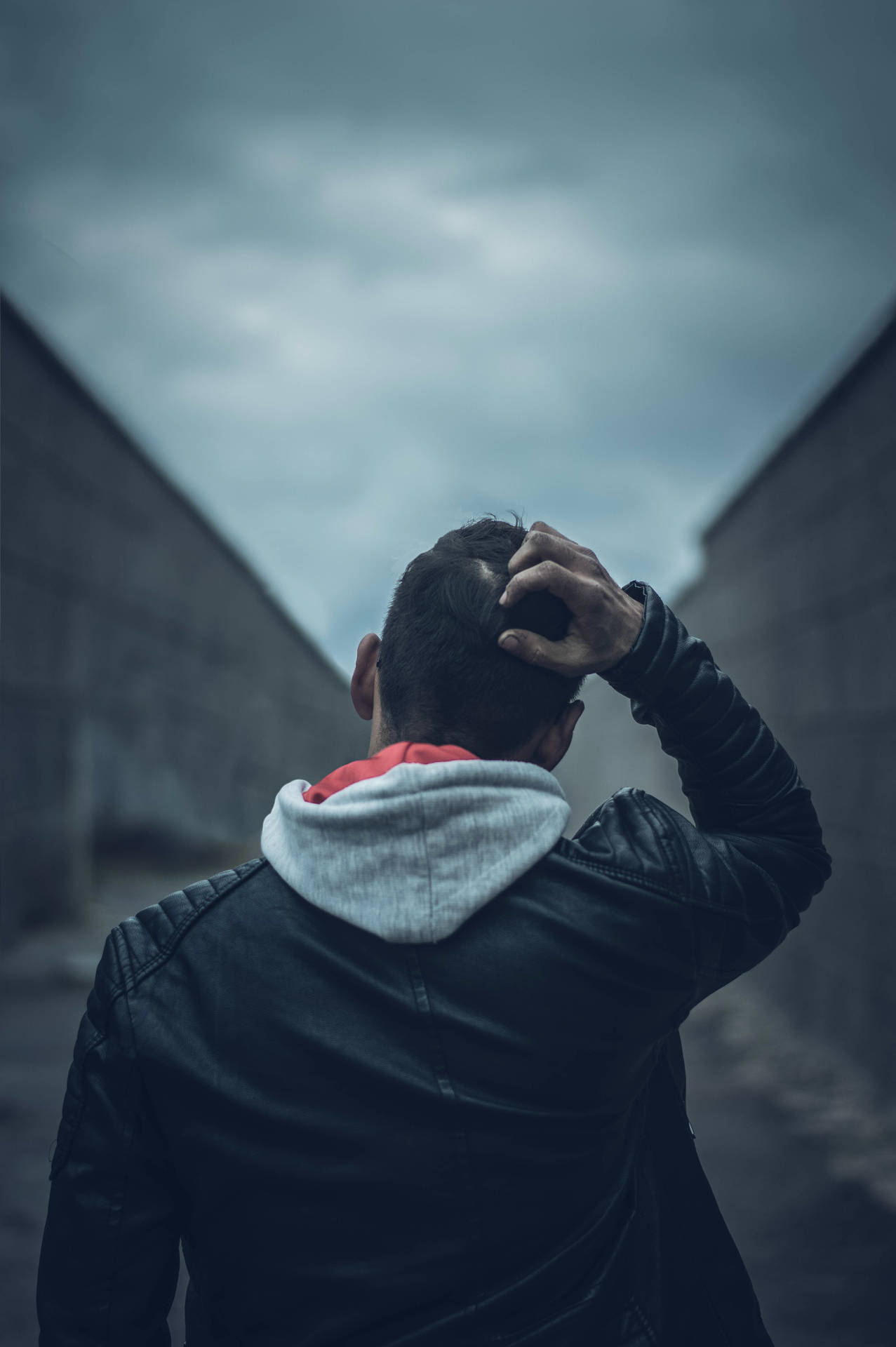 Desolate Emotions - A Solemn Young Boy Against a Vast Perspective Wallpaper