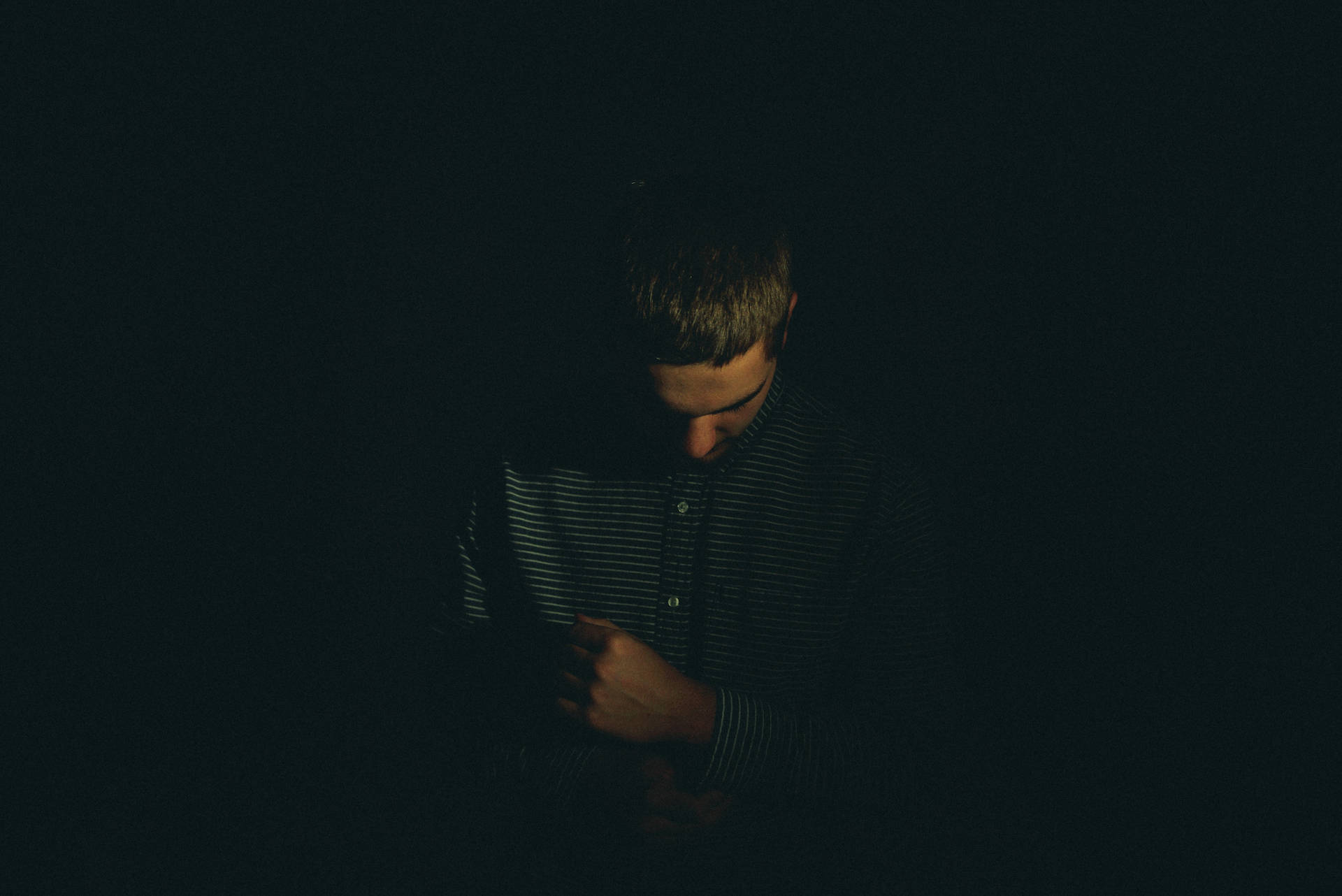 Solitude in Shadows - A Portrait of a Sad Boy Wallpaper