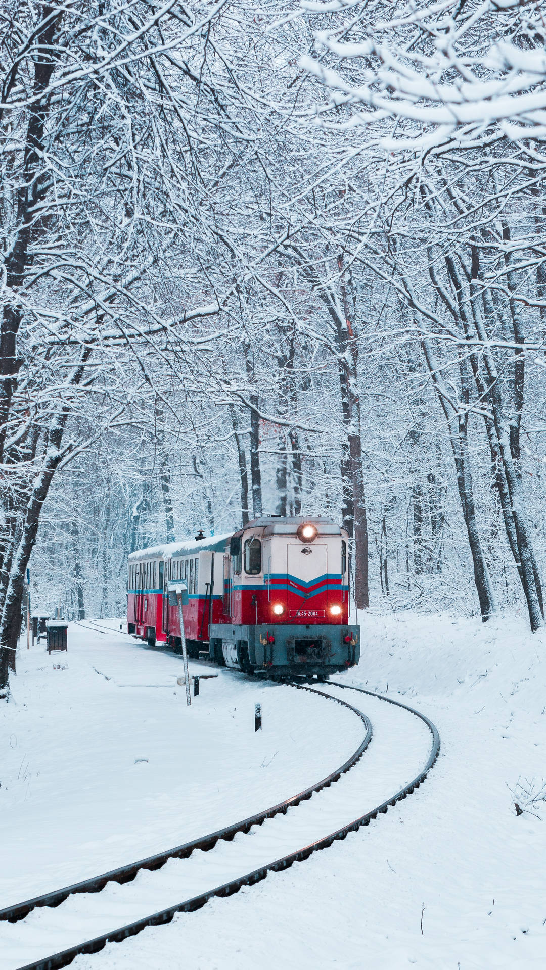 A scenic winter wonderland journey on a vintage train Wallpaper