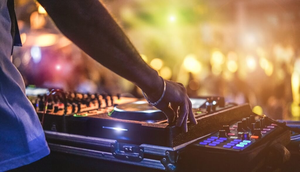 DJ spinning decks at a bar