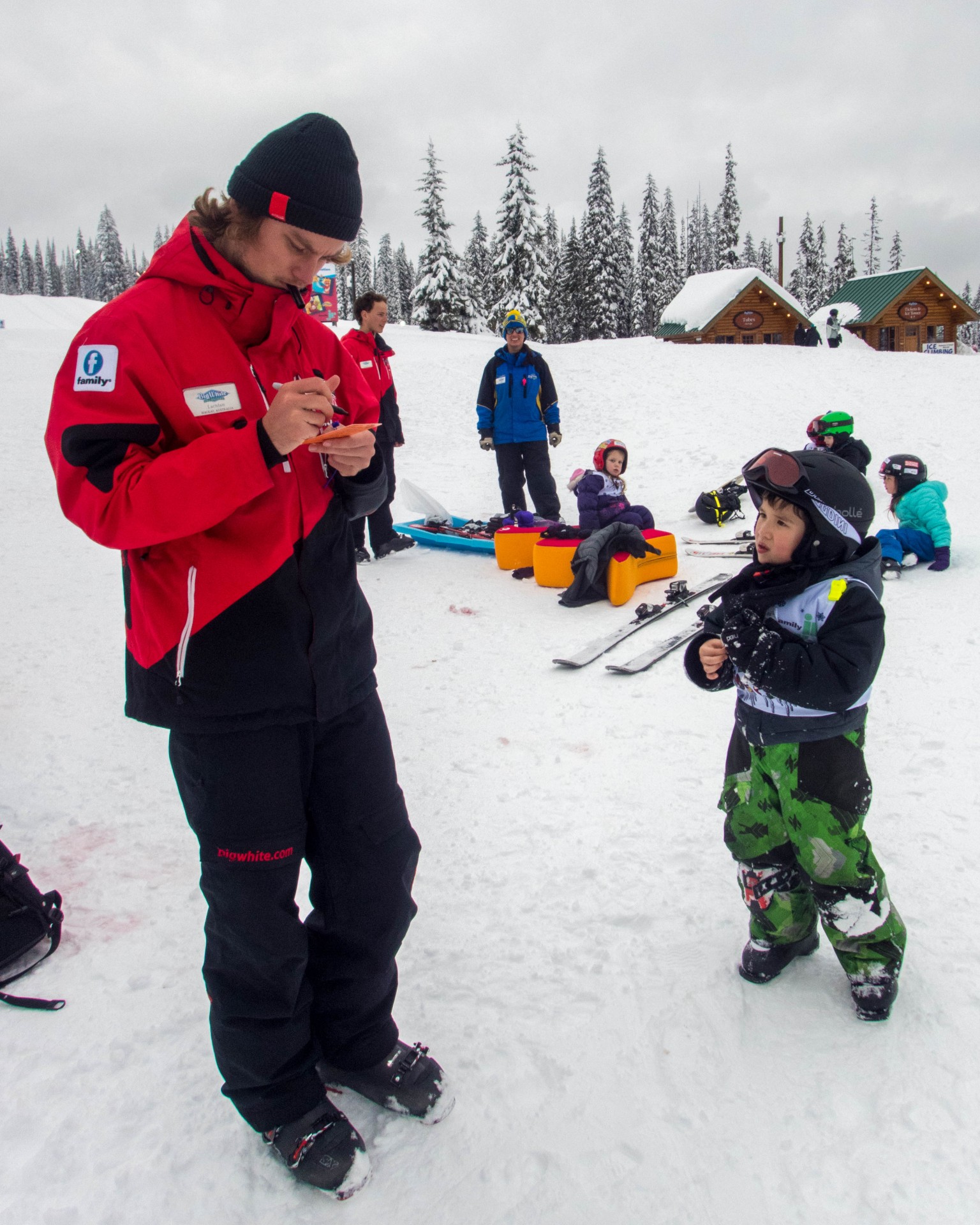 Young boy gets a report card from a ski instructor - Learning to Ski at Kelowna's Big White