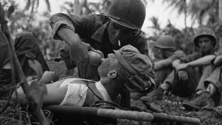 A Navy corpsman gives a drink of water to a wounded Marine on the island of Guam in the Pacific. In addition to the thousands of casualties treated by U.S. Army medical personnel, the U.S. Navy also trained many for the war effort. (All photos: National Archives)­