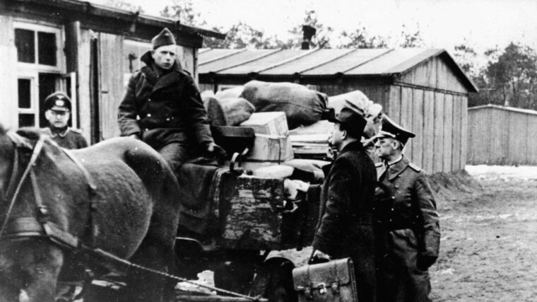 German camp authorities and delegates of the International Red Cross discuss the disposition of packages at Luft Stalag III B.