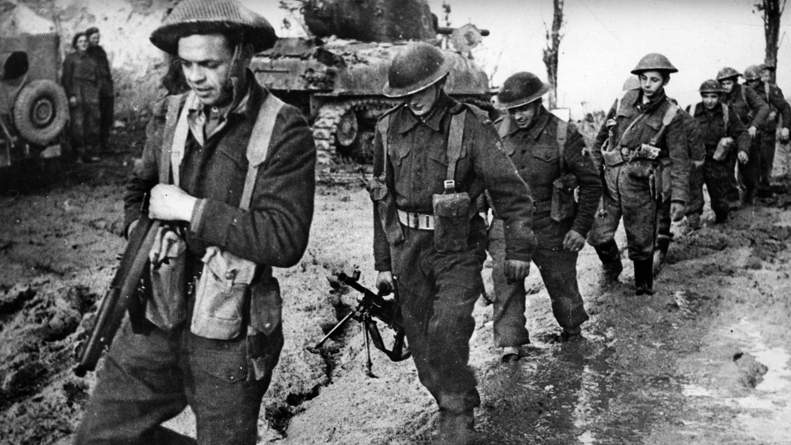 Polish soldiers, attached to the British Eighth Army in Italy, slog along a flooded road.