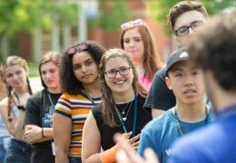 A group of first year Worcester State students participating in an outdoor discussion together during orientation