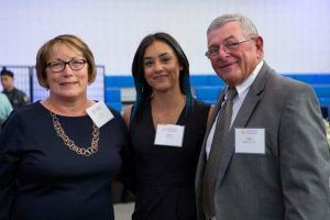 A group of Worcester State alumni smiling for a photo