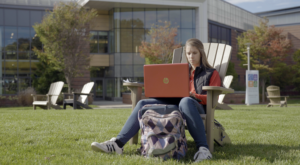 A student working on classwork outside on campus