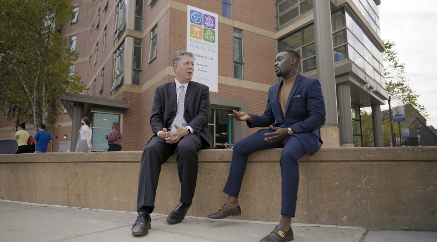 President Barry M. Maloney talking with a student