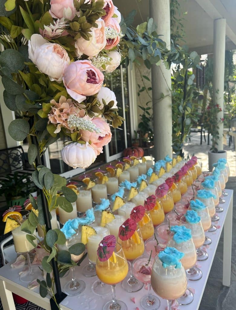 drink display, outdoors, florals hanging on the side, colorful drinks, Sintonia Bartenders, Orlando, FL