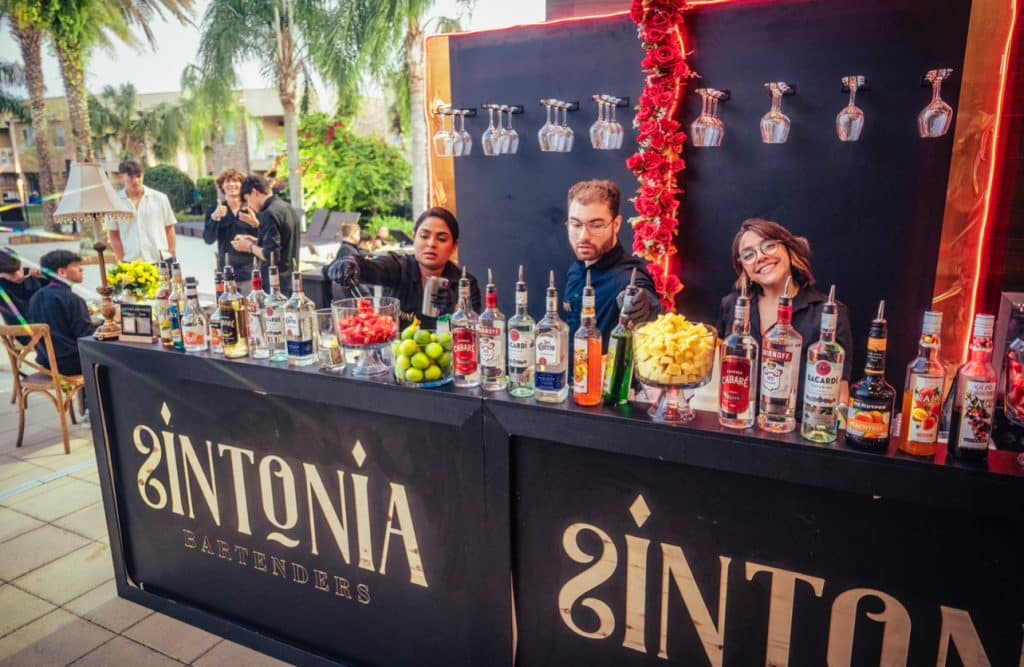 photo of the bar area, logo on the front of each bar area, bartenders preparing drinks, Orlando, FL