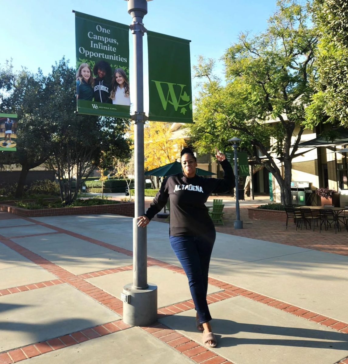 Ms. Mshaka posing in front of a Westridge sign on campus. (Fan Wang)