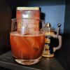 California Surfer cocktail on a bookshelf in front of a mini German beer stein.