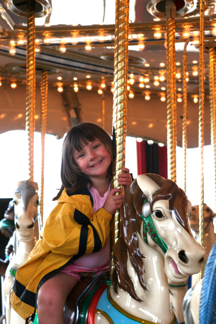 Girl riding Carousel in Old Orchard Maine