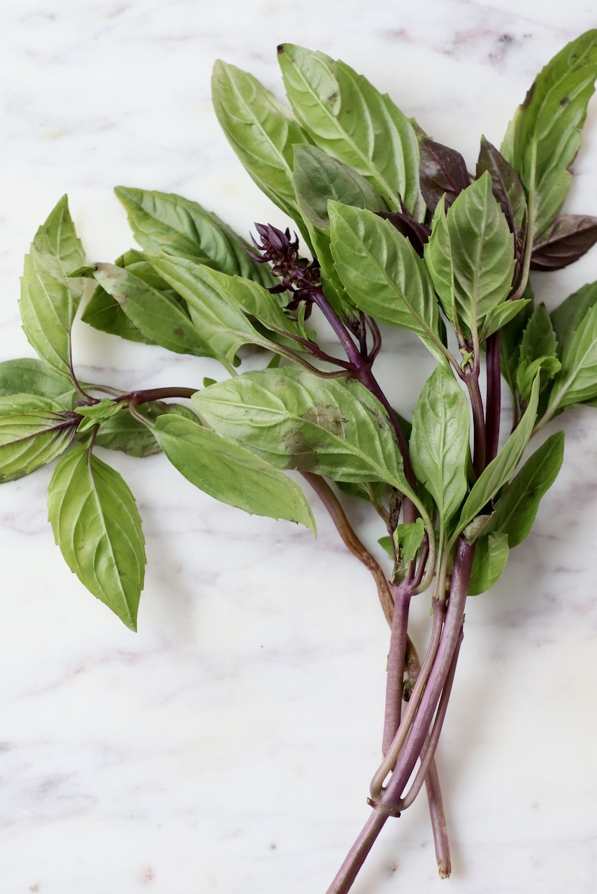 thai basil leaves on marble tray