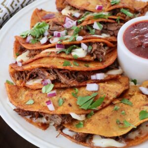 quesabirria tacos stacked up on plate