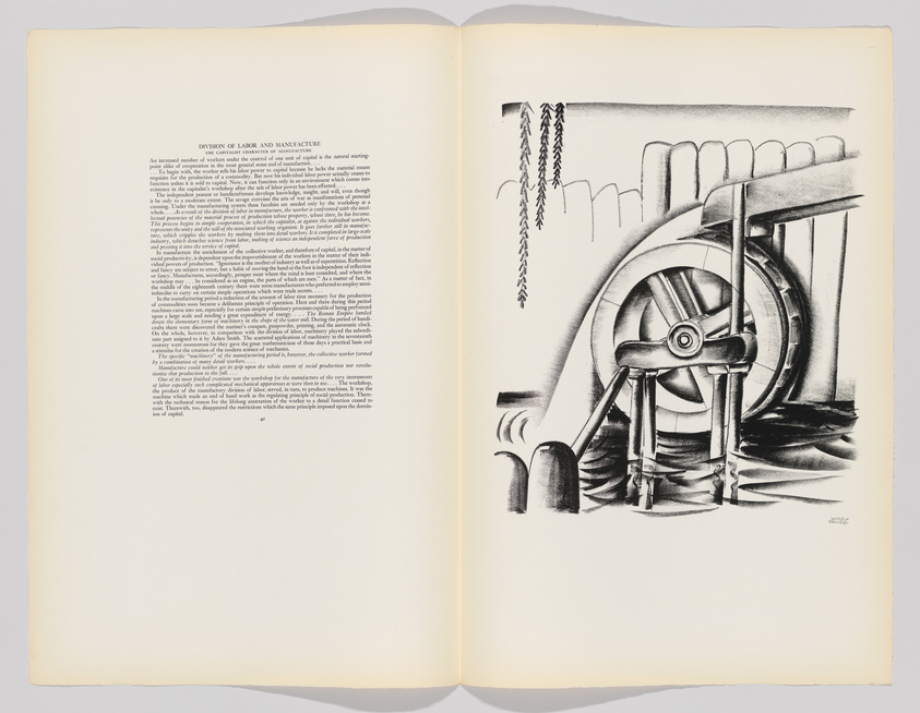 An open book with two pages visible; the left page contains dense text under the heading "DIVISION OF LABOR AND MANUFACTURE," while the right page features a black and white illustration of a large waterwheel and gears, suggesting an industrial or manufacturing setting. The artwork has a vintage or historical style, and there are chains and ropes depicted as part of the machinery.