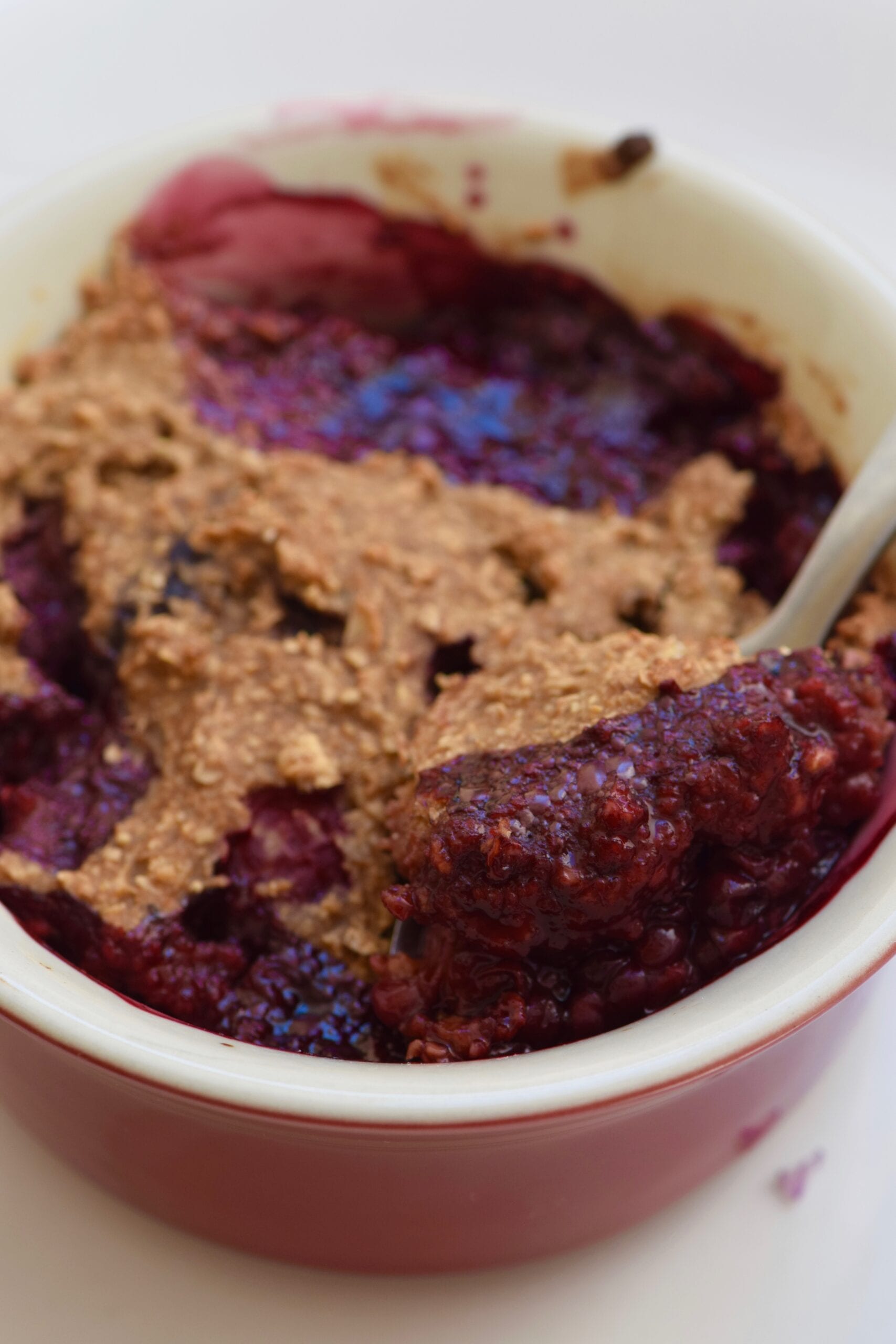 Single serving blueberry cobbler with a spoon