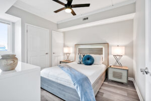 Image of interior of 106 North Water Street with bed and fan with blue bed spread