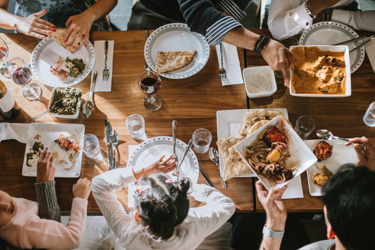 A group of people sharing a Meal Together