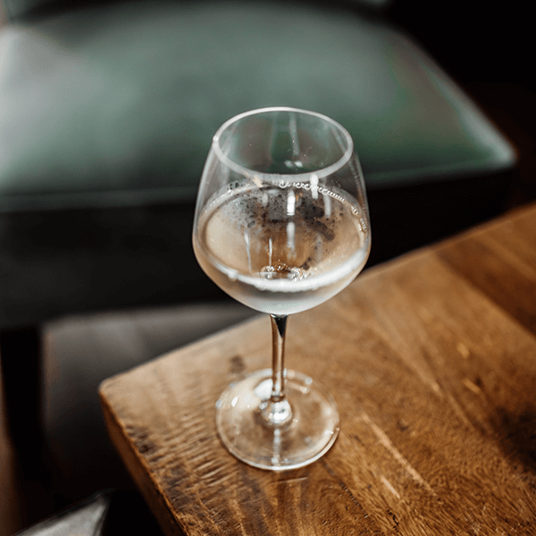 glass of white wine on a table