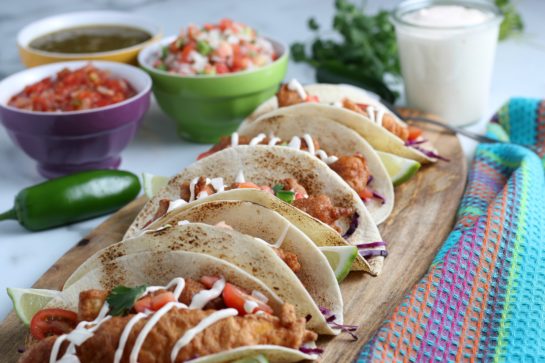 The completed beer-battered Baja Fish Tacos plated with the fish sauce crema on top ready to be enjoyed.