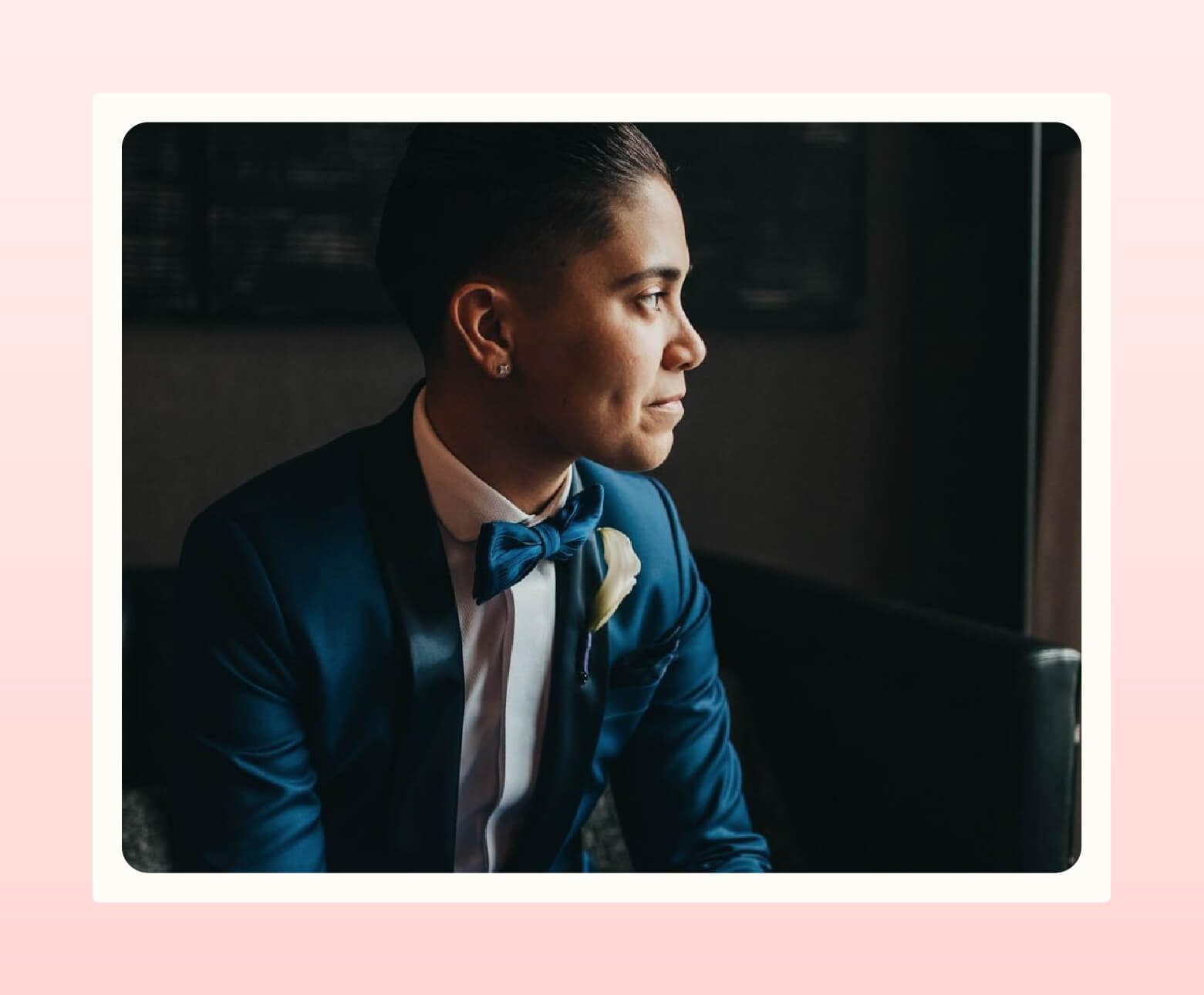 Person wearing a blue wedding suit from Bindle & Keep with matching bow tie while looking away from camera