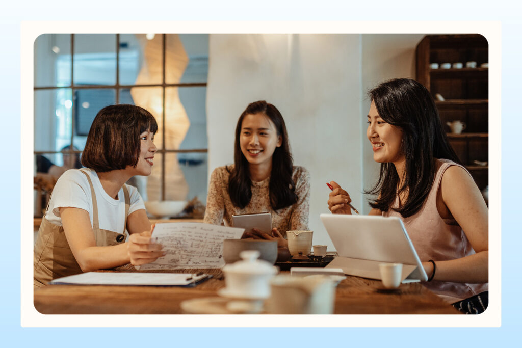 three women discussing party plans for bridal shower