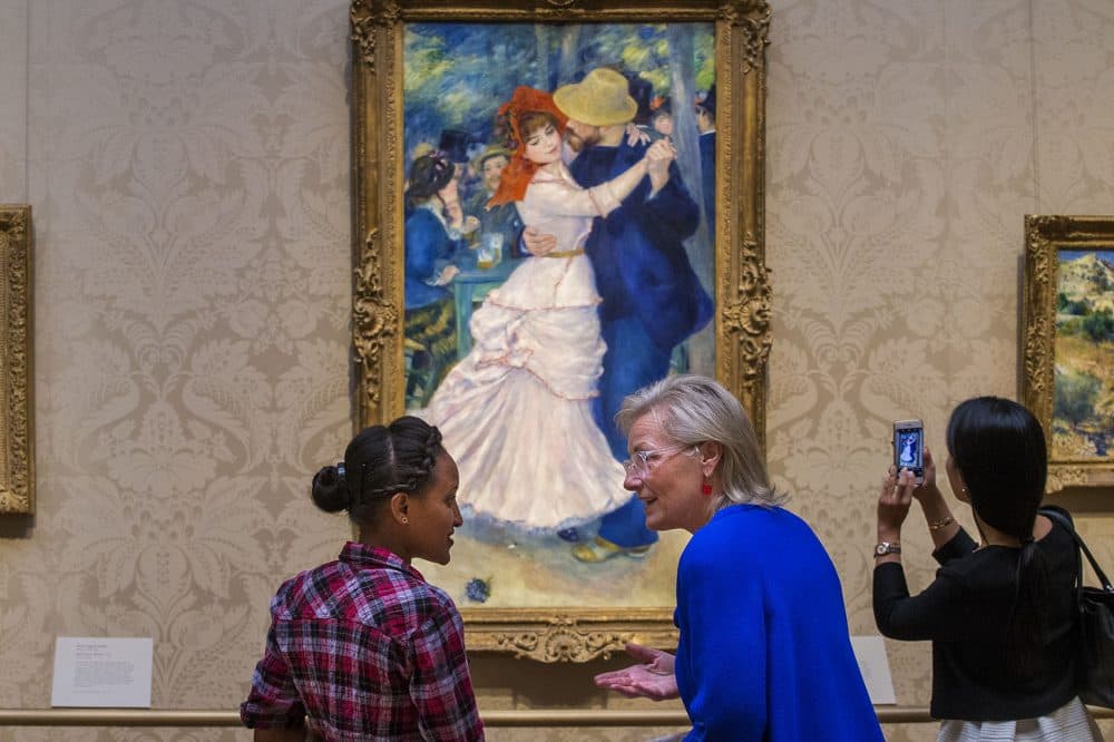 Dorene McCourt describes impressionism to Hiwot Behabtu while they look at Renoir's &quot;Dance at Bougival.&quot; (Jesse Costa/WBUR)