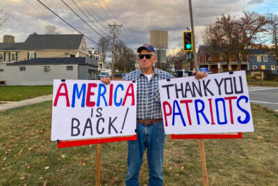 John Mcrae, 83, celebrating Trump's victory at a busy intersection in Leicester on Nov. 6. (Deborah Becker/WBUR)