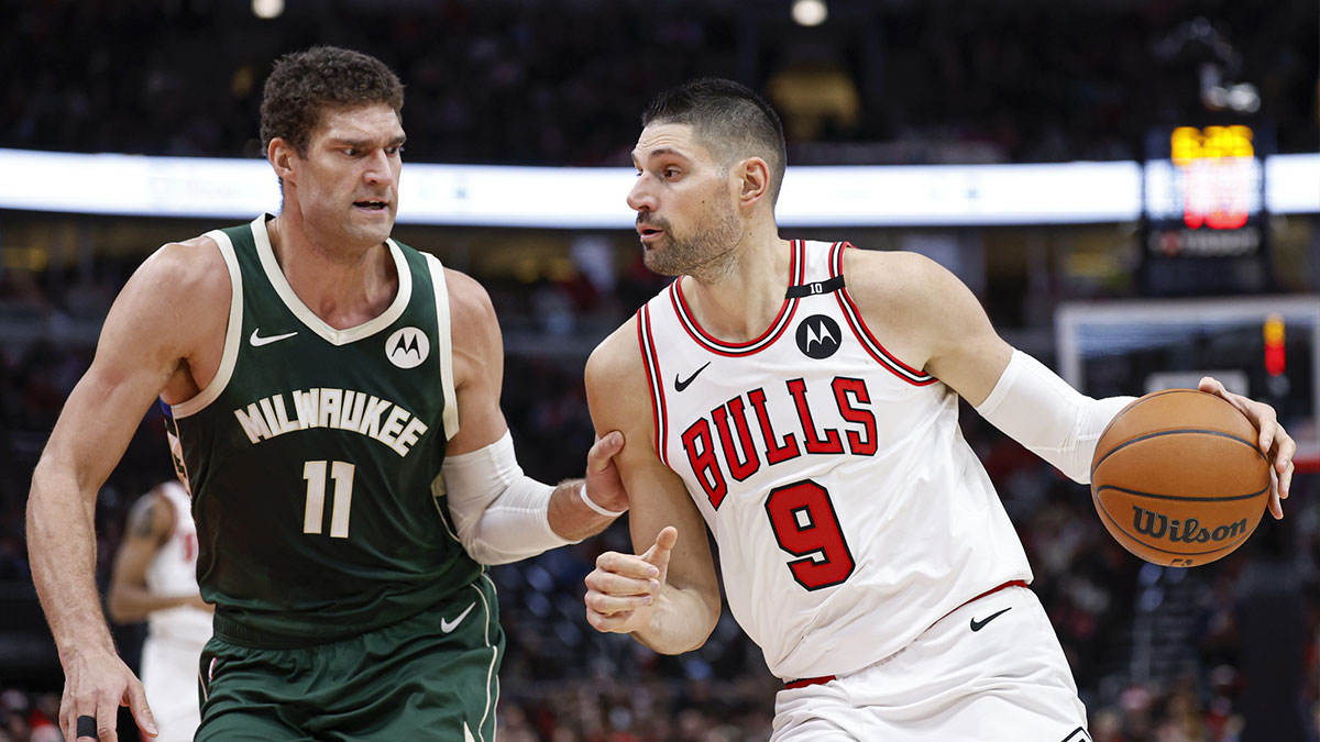 Chicago Bulls center Nikola Vucevic (9) drives to the basket against Milwaukee Bucks center Brook Lopez (11) during the first half at United Center.