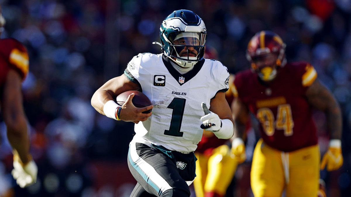 Philadelphia Eagles quarterback Jalen Hurts (1) against Washington Commanders safety Jeremy Chinn (11) during the first quarter at Northwest Stadium.