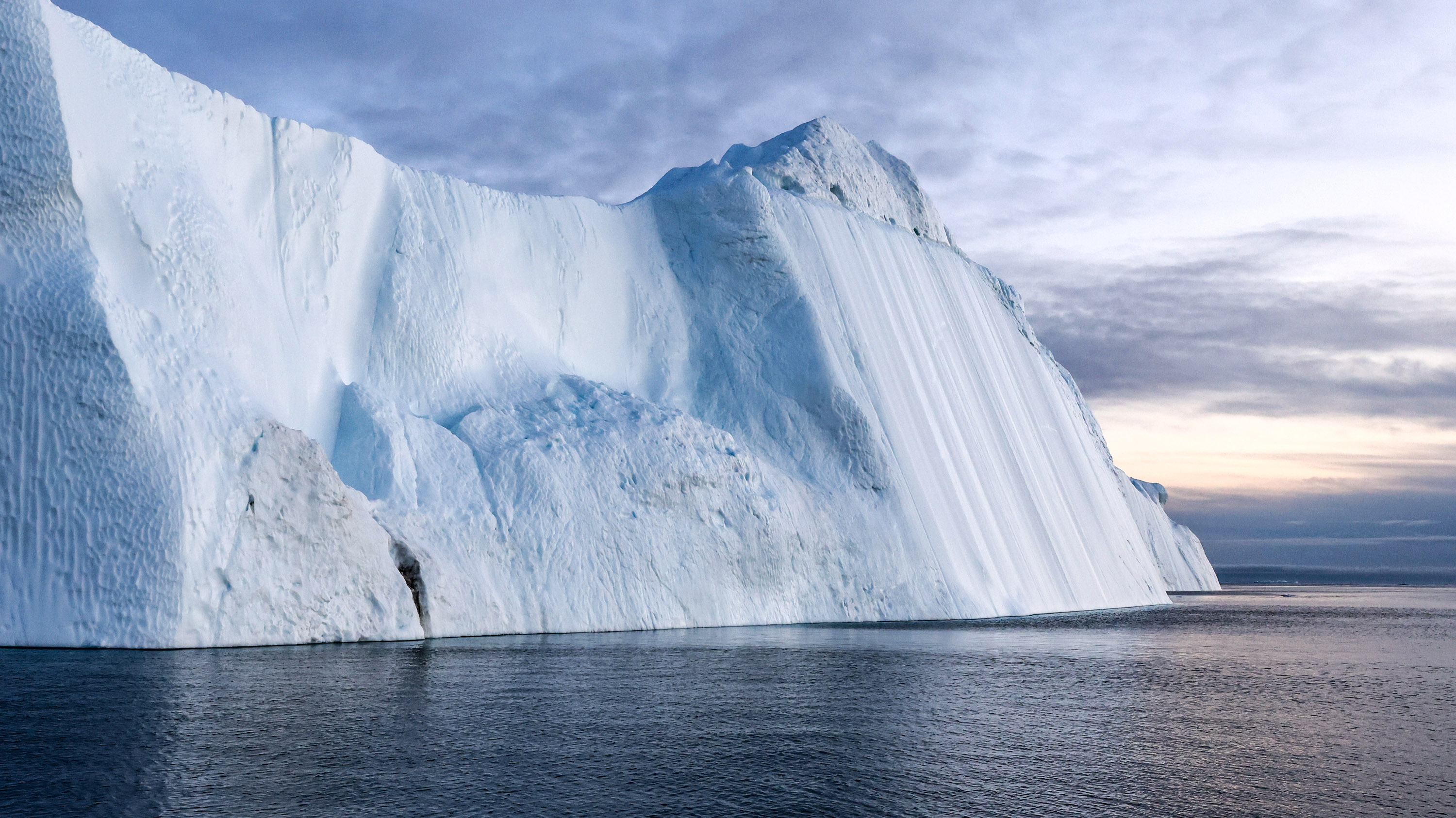 the steep face of an iceberg calved from the Sermeq Glacier