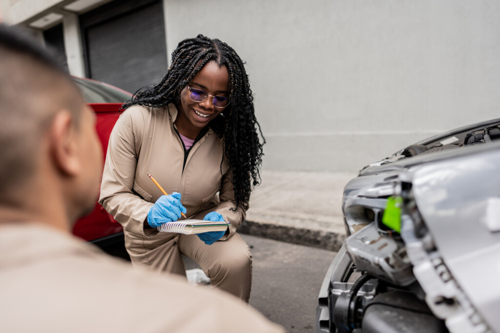 Auto Mechanic Coworkers Working Repairing A Car On The City