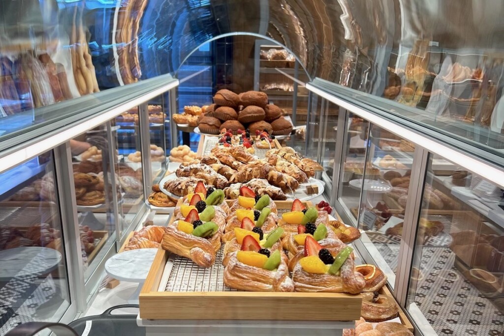 long view of pastry case filled with fruit tarts and pastries