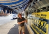 David Sibray rolls out an awning in advance of a July 29 open house at Mount Hope.