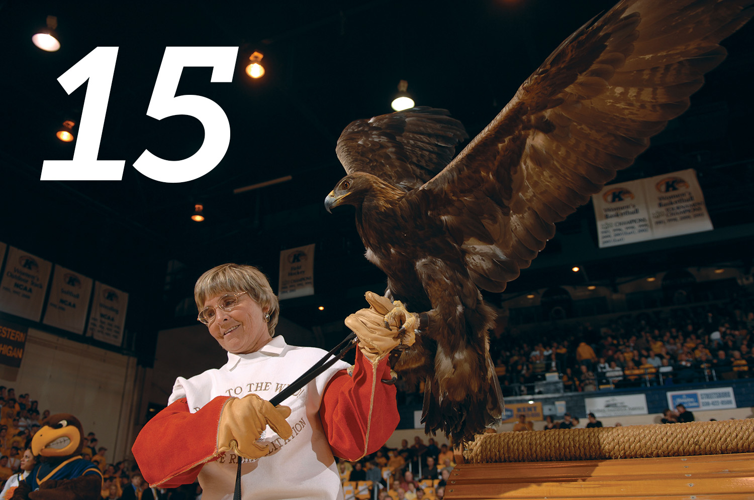 Mona Rutger and rehabilitated eagle at a men's basketball game in 2008